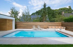 Finition projet piscine en vinylester 8x4 avec plage La Plage 9 de LPW Pools avec mur en bois et poolhouse